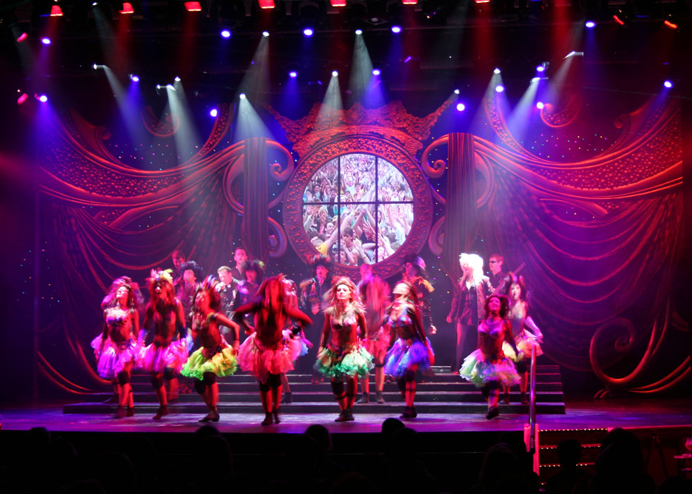 Dancers on stage with scenery and lights